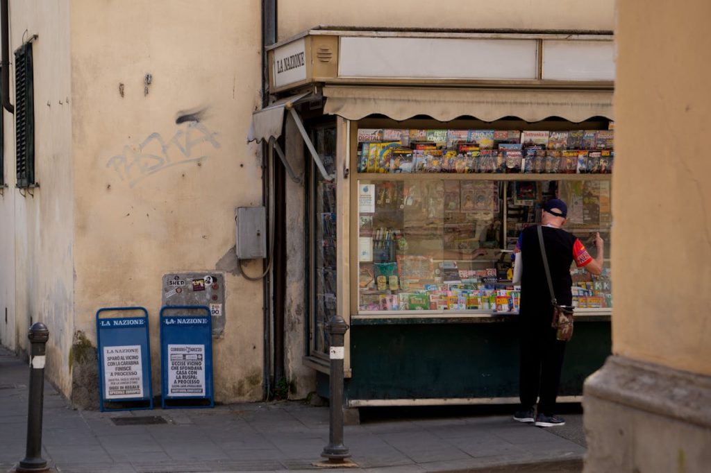 A man is walking down the street with a bag